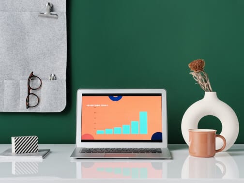 Modern workspace with a laptop displaying data analytics for IT infrastructure and data center solutions.